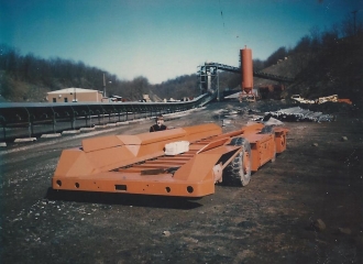 Simco-Peabody #4 U.G. Outside in yard area, shuttle car waiting to inside the mine. The belt line in the foreground that went down to the tipple, and the bath house also in the foreground-April 1972.