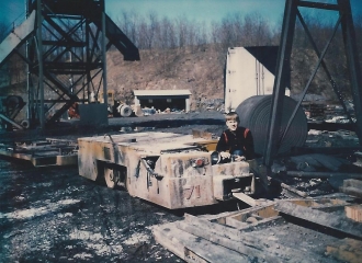 Simco-Peabody #4 U.G. Mine- Motor and flat car we rode into mine on-can see the hand rails on the car, April 1972.
