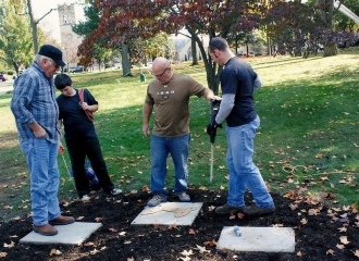 Alan Cottrill in the center, getting the drill from his employee. Template placed on cement pad for statue. October 18, 2013.