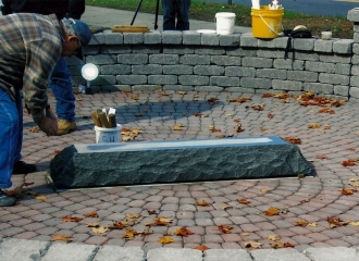 Base stone set in place. Employee prepping the base stone for the header stone placement. October 18, 2013.