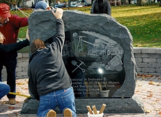 Milligan Memorials employees, along with Bill Albert in red shirt and hat setting the Memorial Stone into place. October 18, 2013.