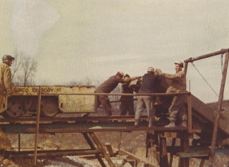 Simco-Peabody Coal Co. #5 U.G. Mine Outside- Employees dumping a car with rock in it at the dump, 1978.