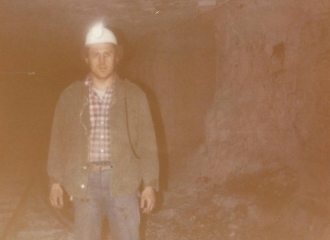 North American Coal Co.-Nov. 1979- Sam Bennett standing on the track entry. Coal Seam height=5 feet high and one foot of rock.
