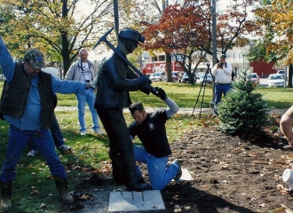 Lowering Bronze Coal Miner Statue down into place. Notice aluminum all thread anchors in statues feet. October 18, 2013.