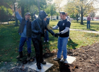 Bronze Coal Miner Statue is sitting flush with the base. Cemented onto base for theft purposes. October 18, 2013.