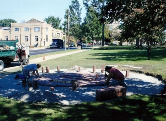 Mike Kobel to the left, Owner of Kobel’s Landscaping and an employee laying down bricks for the patio area of the memorial. September 2013.
