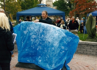 Tim Milligan getting the tarp ready for the unveiling of the Memorial Stone. All family members with connections to the fifty names on back of stone were asked to come forward and help unveil the stone on dedication day, October 19, 2013.