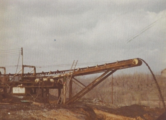 Simco-Peabody Coal Co #5 U.G. Mine Outside- Coal mine belt line dumping coal outside of the mine after belt was shortened in 1978.